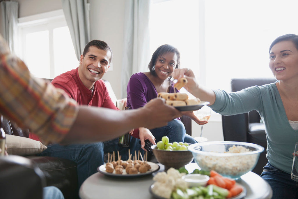 Friends celebrating with snacks at an eco-eriendly house party