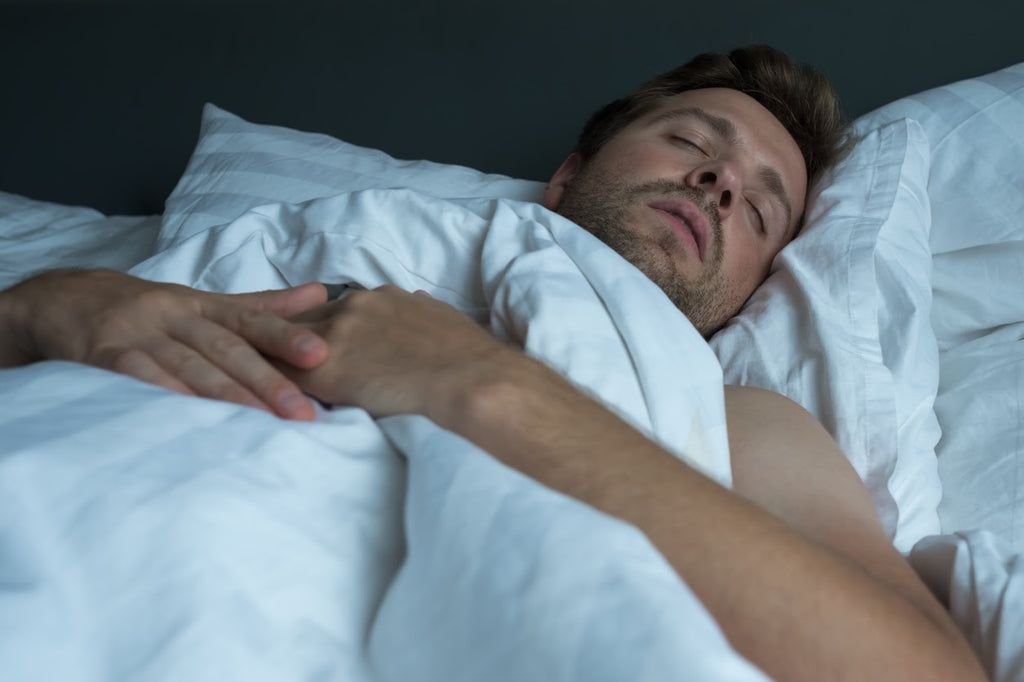 man sleeping receiving health benefits of sound sleep