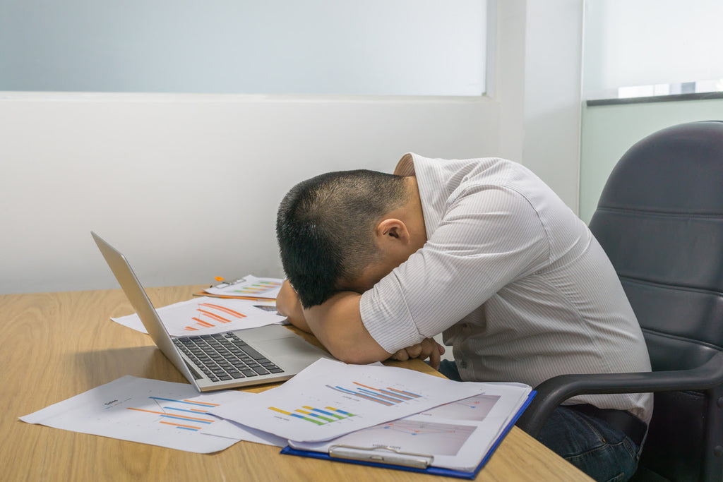 Lack of sleep affecting business man sleeping at desk