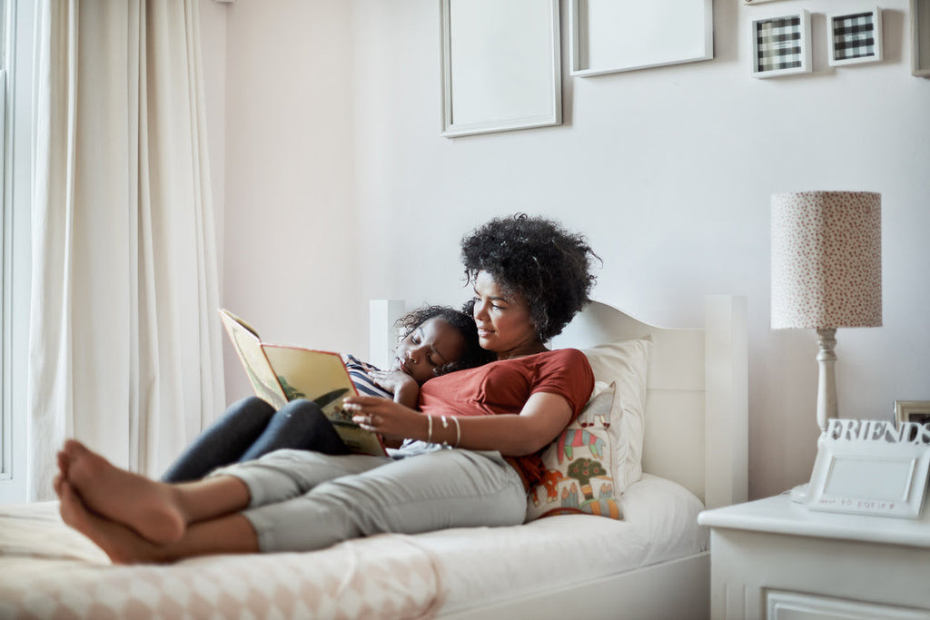 mom reading daughter bedtime story